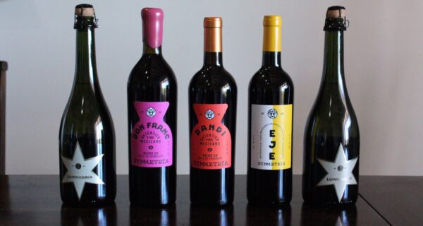 Symmetria’s Liquid Lineup: From bubbly Luminaria to bold reds like Don Franc, Dandi, and Eje—each bottle is a love letter to Baja, handcrafted with balance, heart, and zero shortcuts.