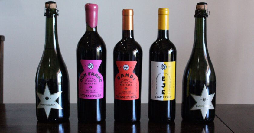 Symmetria’s Liquid Lineup: From bubbly Luminaria to bold reds like Don Franc, Dandi, and Eje—each bottle is a love letter to Baja, handcrafted with balance, heart, and zero shortcuts.